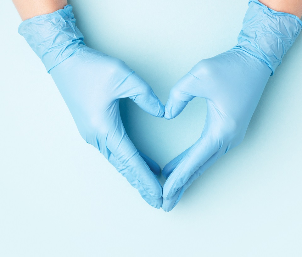 Hands with medical gloves making a heart shape