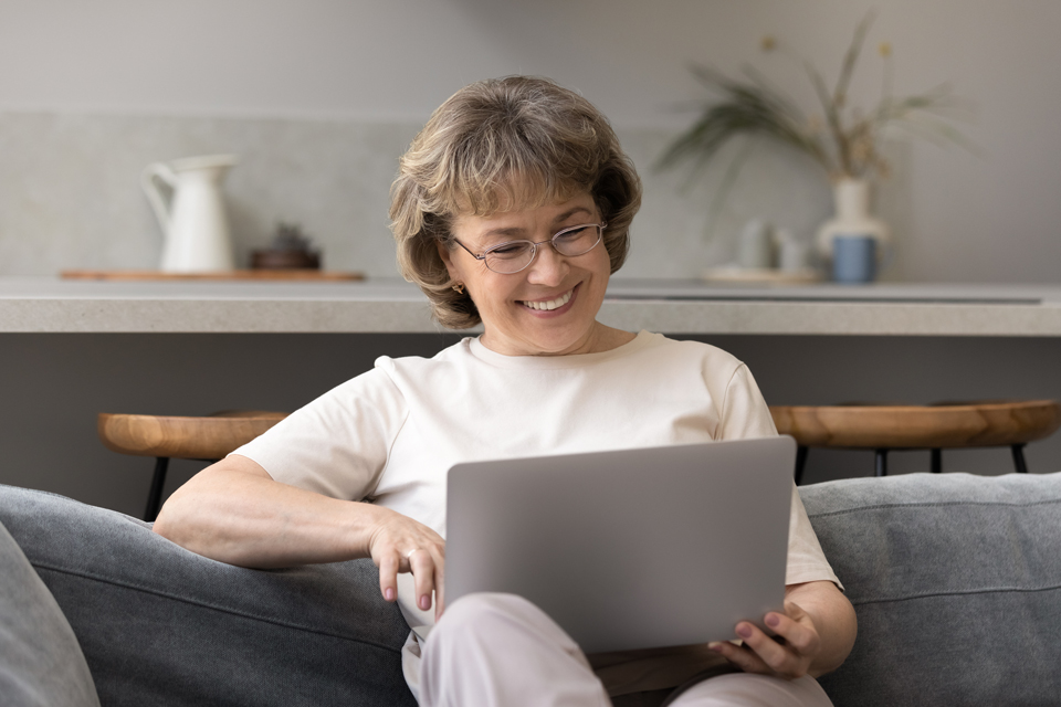 Woman sitting with laptop on her lap