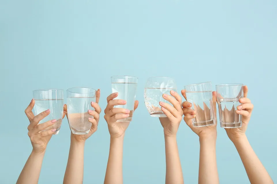 Hands with glasses of water