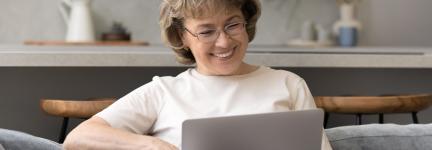 Woman sitting with laptop on her lap